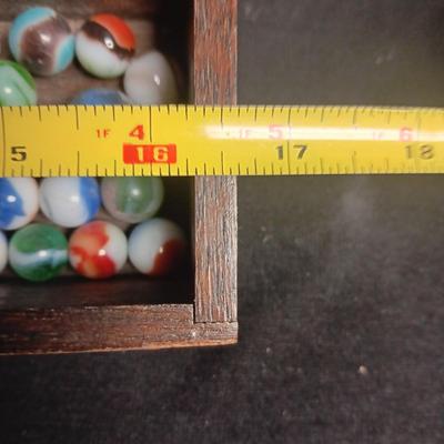 SECTIONED WOODEN BOX WITH A VARIETY OF MARBLES