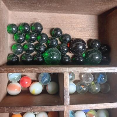 SECTIONED WOODEN BOX WITH A VARIETY OF MARBLES