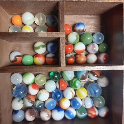 SECTIONED WOODEN BOX WITH A VARIETY OF MARBLES