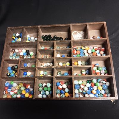 SECTIONED WOODEN BOX WITH A VARIETY OF MARBLES