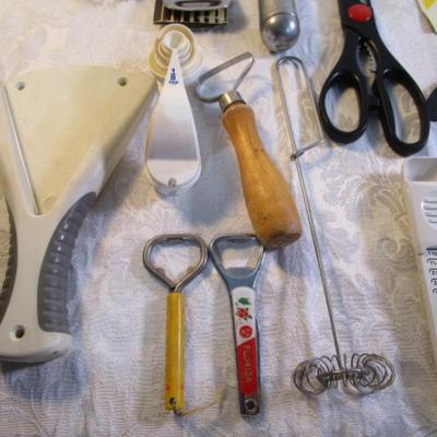 Sale Photo Thumbnail #127: adjustable measuring spoon, spatulasr, measuring spoons, whip, jar openers, pancake forms, can opener, kitchen scissors, peeler, ice cream scoops, ice pick, bottle openers, gas line wrench, tupperware labels, knife, bear trive