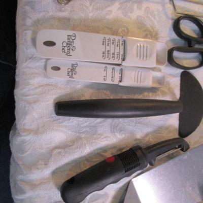 Sale Photo Thumbnail #134: adjustable measuring spoon, spatulasr, measuring spoons, whip, jar openers, pancake forms, can opener, kitchen scissors, peeler, ice cream scoops, ice pick, bottle openers, gas line wrench, tupperware labels, knife, bear trive