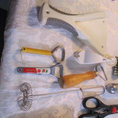 Sale Photo Thumbnail #135: adjustable measuring spoon, spatulasr, measuring spoons, whip, jar openers, pancake forms, can opener, kitchen scissors, peeler, ice cream scoops, ice pick, bottle openers, gas line wrench, tupperware labels, knife, bear trive