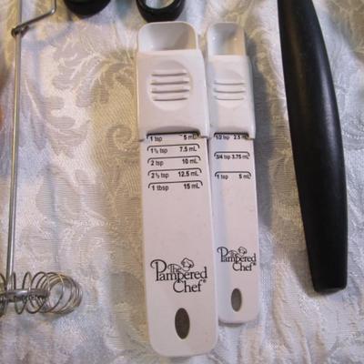 Sale Photo Thumbnail #128: adjustable measuring spoon, spatulasr, measuring spoons, whip, jar openers, pancake forms, can opener, kitchen scissors, peeler, ice cream scoops, ice pick, bottle openers, gas line wrench, tupperware labels, knife, bear trive