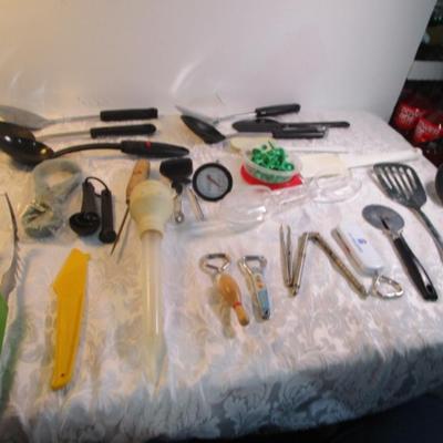 Sale Photo Thumbnail #136: Corn cob holders, new meat thermometer, pizza cutter, can opener, measuring spoons, nut cracker & picks, baster, spatula, 6 serving spoons, tongs, ladle, bottle openers, ice pick, bottle opener, watermelon slicer, tupperware cleaner, rubber spatulas