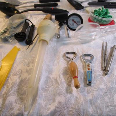 Sale Photo Thumbnail #142: Corn cob holders, new meat thermometer, pizza cutter, can opener, measuring spoons, nut cracker & picks, baster, spatula, 6 serving spoons, tongs, ladle, bottle openers, ice pick, bottle opener, watermelon slicer, tupperware cleaner, rubber spatulas