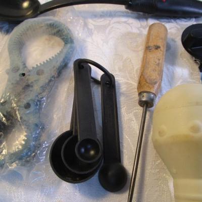 Sale Photo Thumbnail #138: Corn cob holders, new meat thermometer, pizza cutter, can opener, measuring spoons, nut cracker & picks, baster, spatula, 6 serving spoons, tongs, ladle, bottle openers, ice pick, bottle opener, watermelon slicer, tupperware cleaner, rubber spatulas