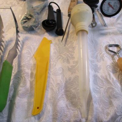 Sale Photo Thumbnail #137: Corn cob holders, new meat thermometer, pizza cutter, can opener, measuring spoons, nut cracker & picks, baster, spatula, 6 serving spoons, tongs, ladle, bottle openers, ice pick, bottle opener, watermelon slicer, tupperware cleaner, rubber spatulas