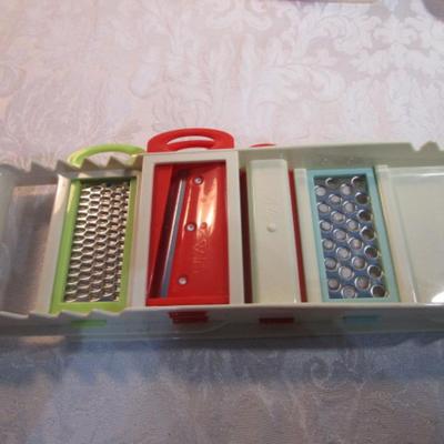 Sale Photo Thumbnail #595: 24 silicone cupcake bakers, box of 100 paper cupcake liners, 9 green and 7 red sundae dishes, multi-function grater, sink strainer, 25 plastic ice cubes inn a plastic lid with lid, 1 8" white plate, 1 new set of 3 funnels, 1 Tupperware funnel, 1 big funne