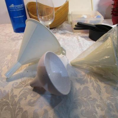 Sale Photo Thumbnail #589: 24 silicone cupcake bakers, box of 100 paper cupcake liners, 9 green and 7 red sundae dishes, multi-function grater, sink strainer, 25 plastic ice cubes inn a plastic lid with lid, 1 8" white plate, 1 new set of 3 funnels, 1 Tupperware funnel, 1 big funne