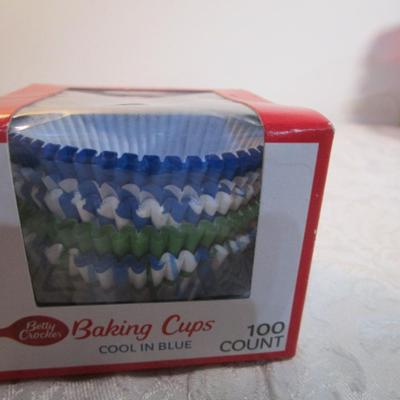 Sale Photo Thumbnail #599: 24 silicone cupcake bakers, box of 100 paper cupcake liners, 9 green and 7 red sundae dishes, multi-function grater, sink strainer, 25 plastic ice cubes inn a plastic lid with lid, 1 8" white plate, 1 new set of 3 funnels, 1 Tupperware funnel, 1 big funne