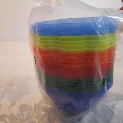 Sale Photo Thumbnail #600: 24 silicone cupcake bakers, box of 100 paper cupcake liners, 9 green and 7 red sundae dishes, multi-function grater, sink strainer, 25 plastic ice cubes inn a plastic lid with lid, 1 8" white plate, 1 new set of 3 funnels, 1 Tupperware funnel, 1 big funne