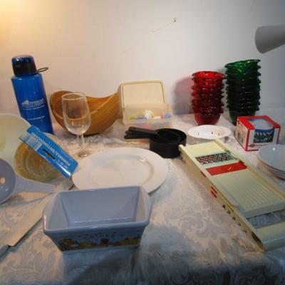 Sale Photo Thumbnail #585: 24 silicone cupcake bakers, box of 100 paper cupcake liners, 9 green and 7 red sundae dishes, multi-function grater, sink strainer, 25 plastic ice cubes inn a plastic lid with lid, 1 8" white plate, 1 new set of 3 funnels, 1 Tupperware funnel, 1 big funne