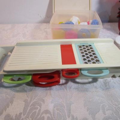 Sale Photo Thumbnail #594: 24 silicone cupcake bakers, box of 100 paper cupcake liners, 9 green and 7 red sundae dishes, multi-function grater, sink strainer, 25 plastic ice cubes inn a plastic lid with lid, 1 8" white plate, 1 new set of 3 funnels, 1 Tupperware funnel, 1 big funne