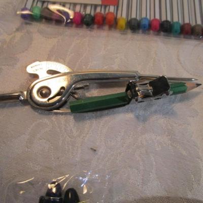 Sale Photo Thumbnail #610: 1 hinge-lid plastic container, stationery kit, greeting cards & Christmas cards, 2 new pkg Acrylic gems (blue & red), teal glass gems, 6' measuring tape, compass, 20 fine markers, 2 pens, container of safety pins