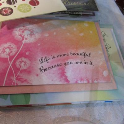 Sale Photo Thumbnail #613: 1 hinge-lid plastic container, stationery kit, greeting cards & Christmas cards, 2 new pkg Acrylic gems (blue & red), teal glass gems, 6' measuring tape, compass, 20 fine markers, 2 pens, container of safety pins