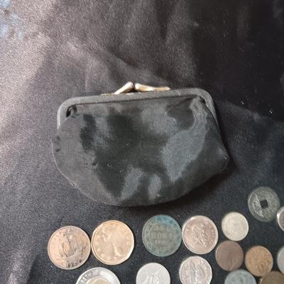 A COLLECTION OF MOSTLY FOREIGN COINS AND 2 OLD COIN PURSES