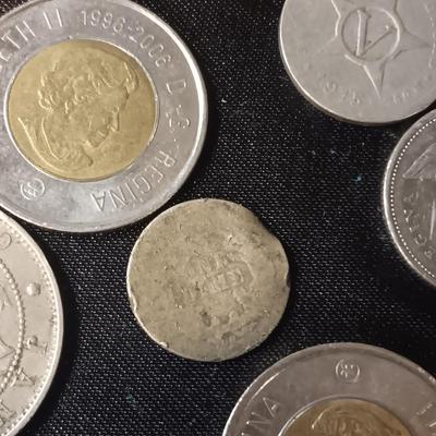 A COLLECTION OF MOSTLY FOREIGN COINS AND 2 OLD COIN PURSES