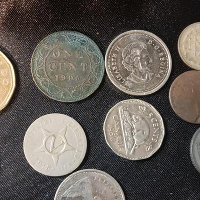 A COLLECTION OF MOSTLY FOREIGN COINS AND 2 OLD COIN PURSES