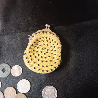 A COLLECTION OF MOSTLY FOREIGN COINS AND 2 OLD COIN PURSES