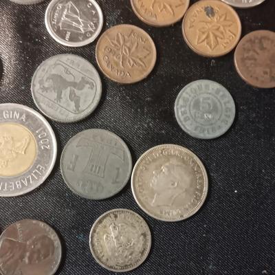 A COLLECTION OF MOSTLY FOREIGN COINS AND 2 OLD COIN PURSES