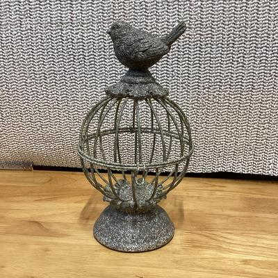 small gray distressed metal decorative bird cage cloche with a bird finial