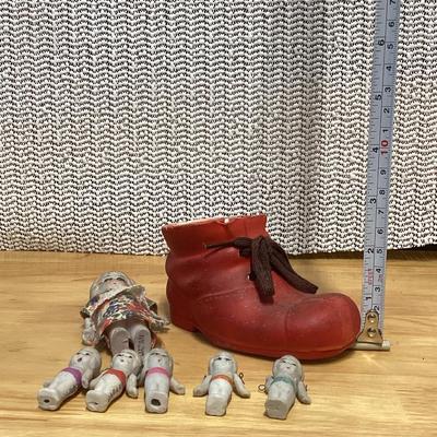 Porcelain shoe and dolls. Old woman and all her children