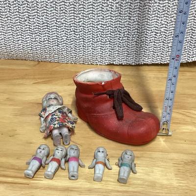 Porcelain shoe and dolls. Old woman and all her children