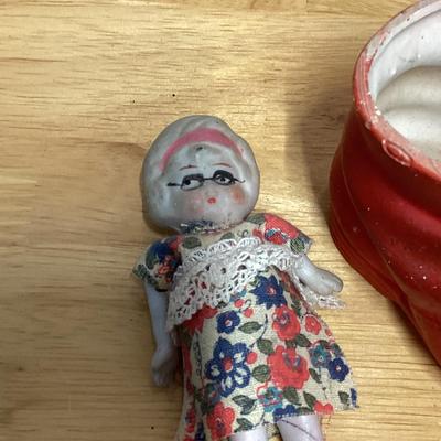 Porcelain shoe and dolls. Old woman and all her children