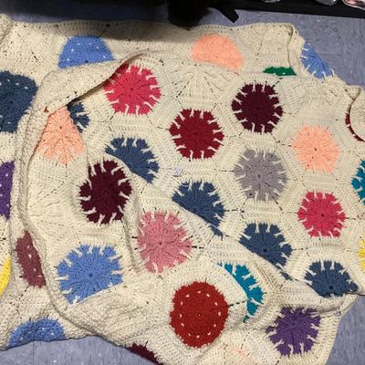 vintage multicolor hand crocheted Afghan blanket made of hexagon sunburst or granny squares