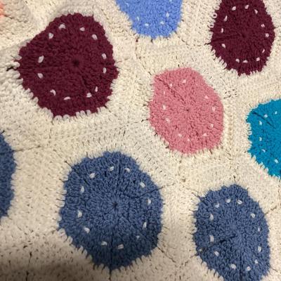 vintage multicolor hand crocheted Afghan blanket made of hexagon sunburst or granny squares