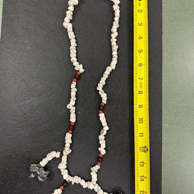 Sale Photo Thumbnail #75: Vintage Hand Carved Foo Dog Totem Necklace featuring white chip style beads, red beads and black beads
See Photo for size