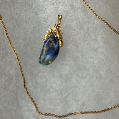 Sale Photo Thumbnail #238: Black or boulder opal, set in 14K setting with accent diamonds
Freeform shape, the opal is 11.4mm x 21.4mm. x 3.6 mm, about 4 carats
Beautiful color in the stone.