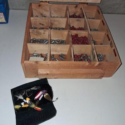 A SECTIONED BOX OF VARIOUS SIZE FISHING SINKERS AND SOME LURES IN A HOLDER