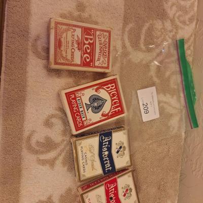 collection of playing cards, including Bicycle Rider Back, Bee 92 Club Special, and Aristocrat Club Special decks