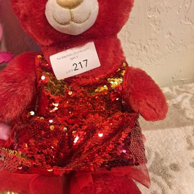  Build-A-Bear Workshop teddy bear in a red, sequined outfit and a "Trolls World Tour" Pop Music Poppy figure. 