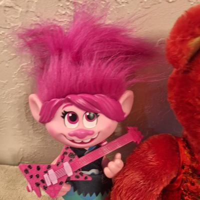  Build-A-Bear Workshop teddy bear in a red, sequined outfit and a "Trolls World Tour" Pop Music Poppy figure. 