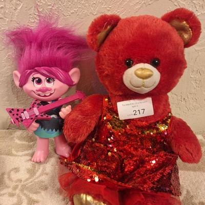  Build-A-Bear Workshop teddy bear in a red, sequined outfit and a "Trolls World Tour" Pop Music Poppy figure. 