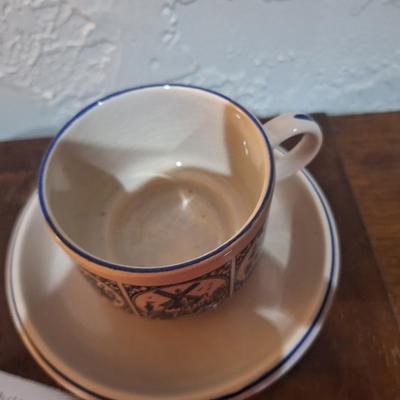 vintage Delft Blue ceramic teacup and saucer set, featuring a classic Dutch windmill and floral design
