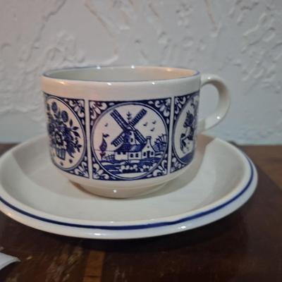 vintage Delft Blue ceramic teacup and saucer set, featuring a classic Dutch windmill and floral design