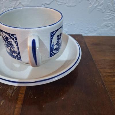 vintage Delft Blue ceramic teacup and saucer set, featuring a classic Dutch windmill and floral design