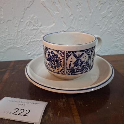 vintage Delft Blue ceramic teacup and saucer set, featuring a classic Dutch windmill and floral design