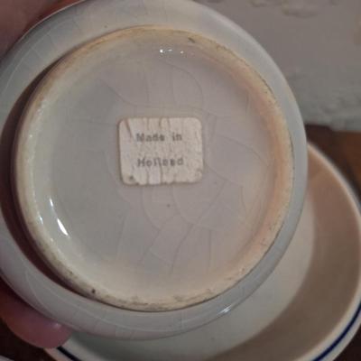 vintage Delft Blue ceramic teacup and saucer set, featuring a classic Dutch windmill and floral design