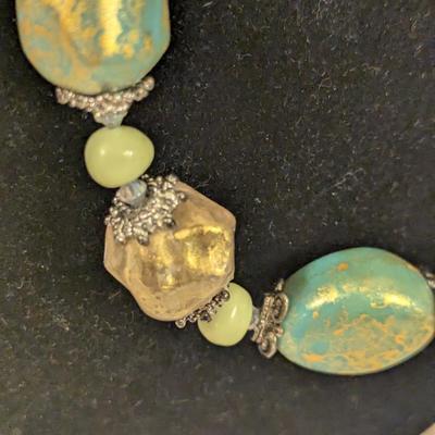 Beautiful beaded necklace with greens and golds irregularly shaped beads