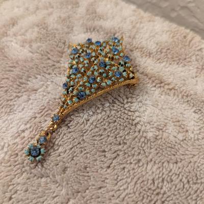 Vintage kite shaped gold tone brooch with light blue stones