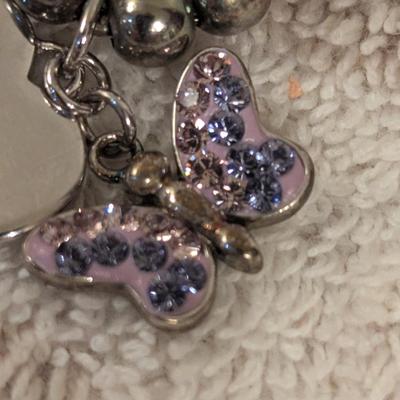 "Truly Inspired" silver-plated adjustable bracelet with a butterfly charm made with Swarovski® crystals.