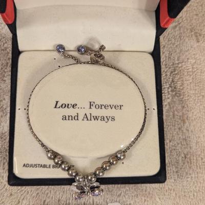 "Truly Inspired" silver-plated adjustable bracelet with a butterfly charm made with Swarovski® crystals.