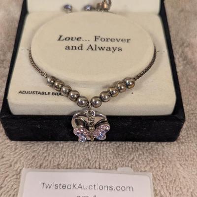 "Truly Inspired" silver-plated adjustable bracelet with a butterfly charm made with Swarovski® crystals.