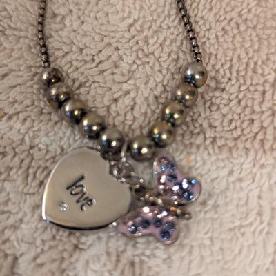 "Truly Inspired" silver-plated adjustable bracelet with a butterfly charm made with Swarovski® crystals.