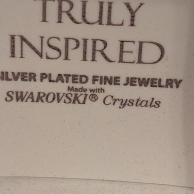 "Truly Inspired" silver-plated adjustable bracelet with a butterfly charm made with Swarovski® crystals.